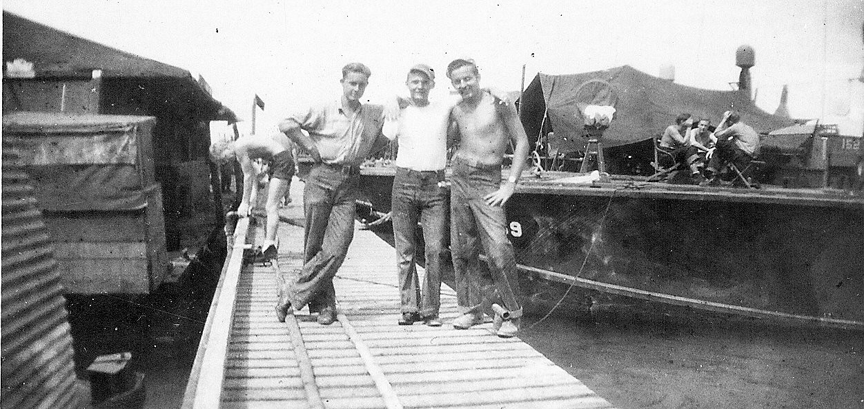 PT-152 alongside a pier, the number 152 on the hull